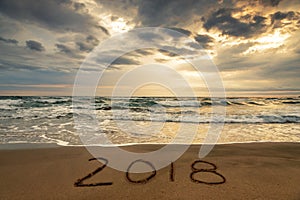 2018 written on the sand of a beach, travel 2018 new year concept