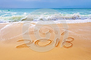 2018 written on the sand of a beach, travel new year concept