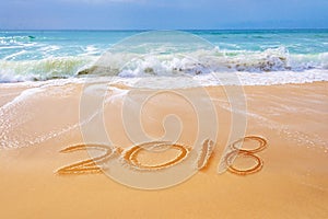 2018 written on the sand of a beach, travel new year concept
