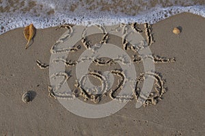 2019/2020 numbers written on the sand