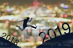 2019 brave man successful concept,silhouette man jumping over gap between building, city scape, landscape to 2019 new year, feel l