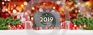 2019 card greetings laying on red baubles and gift 3D rendering