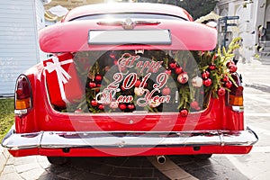 2019 Christmas and new year concepts,An opened red car trunk filled with cloth bags full of gifts and decorations for