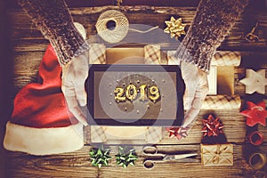 2019. Concept New Year. Tablet PC, New Year`s gifts.