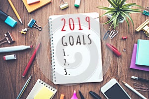 2019 goals text on notepad with office accessories.Business plan