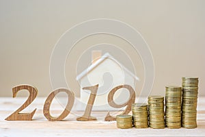 2019 Happy New Year with gold coins stack and wooden number on table. business, investment, retirement planning, finance, Saving a