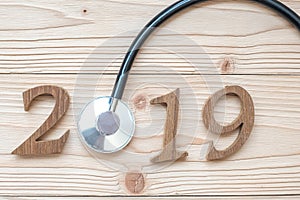 2019 Happy New Year for healthcare, Wellness and medical concept. Stethoscope with wooden number on table