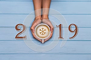 2019 happy new year text on blue wooden background, banner with copy space for text