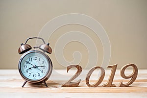 2019 Happy New years with retro alarm clock and wooden number on table and copy space. New Start, Resolution, Goals and Mission