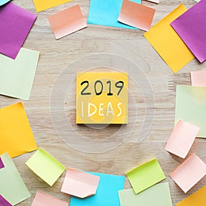 2019 ideas concepts with colorful notepaper on wood table.