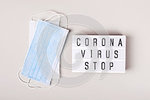 2019-nCoV Coronavirus originating in Wuhan, China. Medical mask and lightboard with words Coronavirus stop. treatment concept