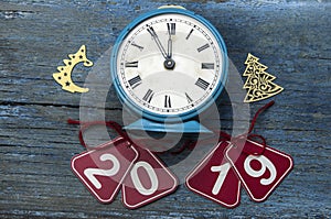 2019 new year and alarm clock on blue wood table with copy space