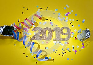 2019 new year party abstract concept with champagne and confetti on yellow background