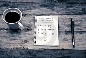 2019 New Year Resolutions written on notebook and coffee on wood table in Goals for happy life