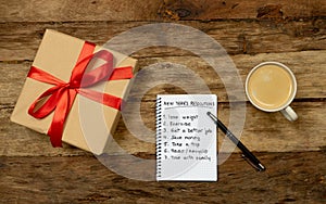 2019 New Year Resolutions written on notebook with Gift and coffee on wood table in Better life goals