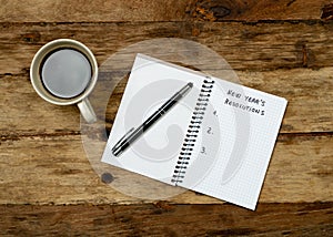 2019 New Year Resolutions written on notebook with Gift and coffee on wood table in Better life goals