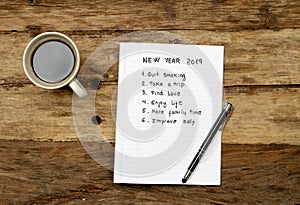 2019 New Year written on notebook with coffee on wood table on resolutions and goals for happy life