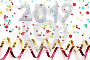 2019 party background with confetti and  paper streamers on white background.