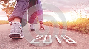 2019 symbolises the start into the new year.Start of people running on street,with sunset light.Goal of Success