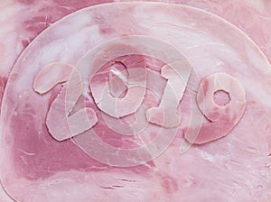 2019 year digits on the pork ham background