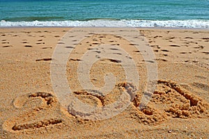 2019 YEAR inscription written in the wet yellow beach sand. Concept of celebrating the New Year, party on the shores of the