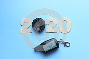 2020. The concept of the new year. The figures 2020 are isolated on a blue background, instead of the number 0 car wheel.