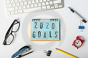 2020 Goals. New year goal, plan, action text on notepad with office supplies. Business motivation concepts ideas
