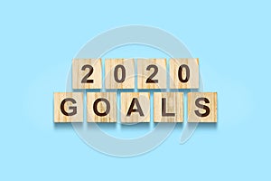 2020. Goals. Words on wooden blocks. Isolated on a blue background. Business. Action.