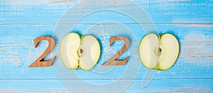 2020 Happy New Year and New You with green apple on blue wood background. Goals, Healthy, Healthcare, Resolution, Time to New