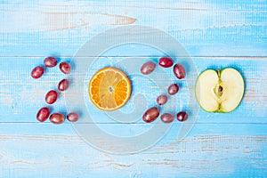2020 Happy New Year and New You with green apple and Orange fruits on blue wood background. Goals, Healthy, Healthcare, Resolution