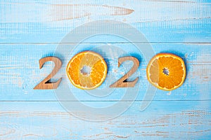 2020 Happy New Year and New You with Orange fruit on blue wood background. Goals, Healthy, Healthcare, Resolution, Time to New