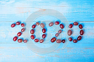 2020 Happy New Year and New You with Red grapes on blue wood background. Goals, Healthy, Healthcare, Resolution, trends, Time to