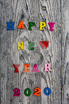 2020 Happy New year text for greeting card on wooden background, calendar, invitation