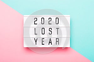 2020 lost year concept. Lightboard with text 2020 lost year on paper geometric background