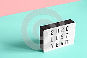 2020 lost year concept. Lightboard with text 2020 lost year on paper geometric background. Trend isometric view for your design