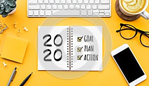 2020 new year goal,plan,action text on notepad with office accessories.Business motivation,inspiration concepts