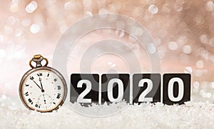 2020 New Years eve celebration. Minutes to midnight on an old watch, bokeh festive