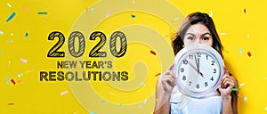 2020 New Years Resolutions with young woman holding a clock