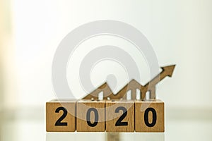 2020 Planning,  Business and Goal Concept. Close up of wooden number blocks with wood chart arrow icon diecut with copy space