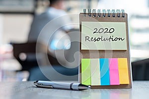 2020 Resolution word on note paper with pen on wooden table. strategy, solution, goal, business, New Year New You and happy