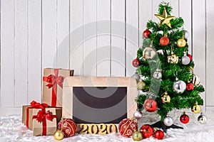 2020 wooden text with Christmas tree and ornaments with gifts boxes