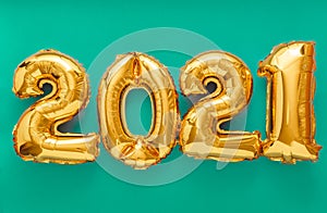 2021 air balloon gold text on green background. Happy New year eve invitation with Christmas gold foil balloons 2021