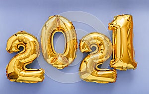 2021 air balloon gold text on violet background. Happy New year eve invitation with Christmas gold foil balloons 2021