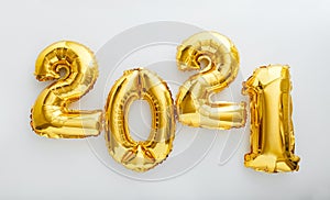 2021 balloon text on white background. Happy New year eve invitation with Christmas gold foil balloons 2021. Flat lay long web