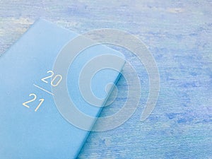 2021 blue diary on aqua blue ink striped textured background.
