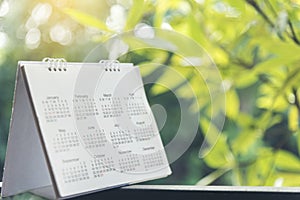 2021 Calendar Event Planner. Close up on calendar on desk with bokeh and sun light as a background with copy space. Schedule using