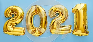 2021 golden balloon text on blue background. Happy New year eve invitation with Christmas gold foil balloons 2021. Flat lay long