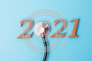 2021 Happy New Year for healthcare, Wellness and medical concept. Stethoscope and wooden number on blue background