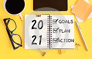 2021 new year goal,plan,action concepts with text on notepad and office accessories.Business management,Inspiration to success