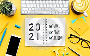 2021 new year goal,plan,action text on notepad with office accessories.Business management,Inspiration concepts